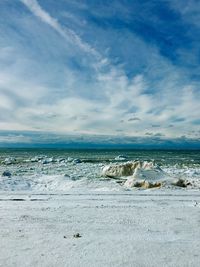 Scenic view of sea against cloudy sky