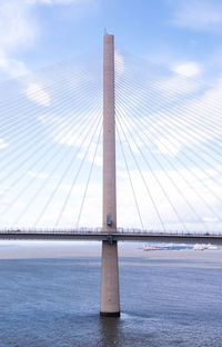 View of suspension bridge against cloudy sky