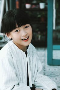 Portrait of smiling girl sitting on floor