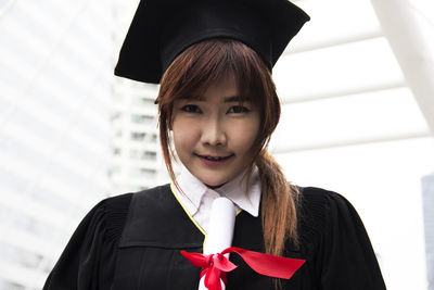 Young woman standing against building