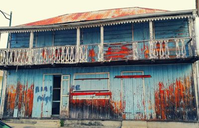 Graffiti on house against sky