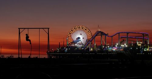 Illuminated ferris wheel at night