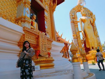 Woman standing against temple building