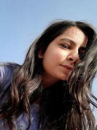 Portrait of beautiful woman against sky