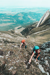 High angle view of people on rock against mountains