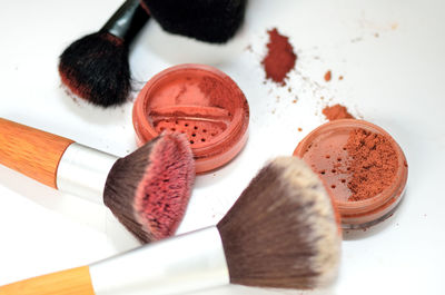 Close-up of eyeshadow and make-up brushes on table