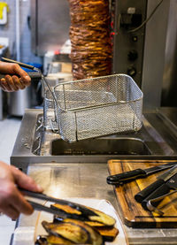 Cropped hands of man preparing food in kitchen