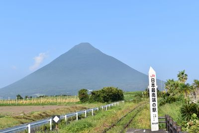 Road leading towards mountains against sky