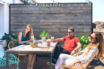 Group of friends having a drink at a party on a terrace