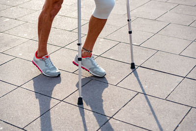 Low section of man standing on footpath