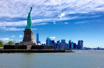 Statue of liberty by hudson river in city