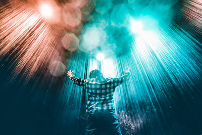 Man with illuminated lighting equipment in sea