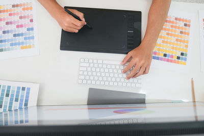 Low angle view of person using laptop on table