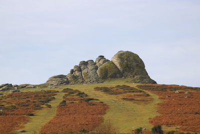 Low angle view of rock formations against sky