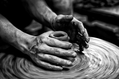 Midsection of man working in mud