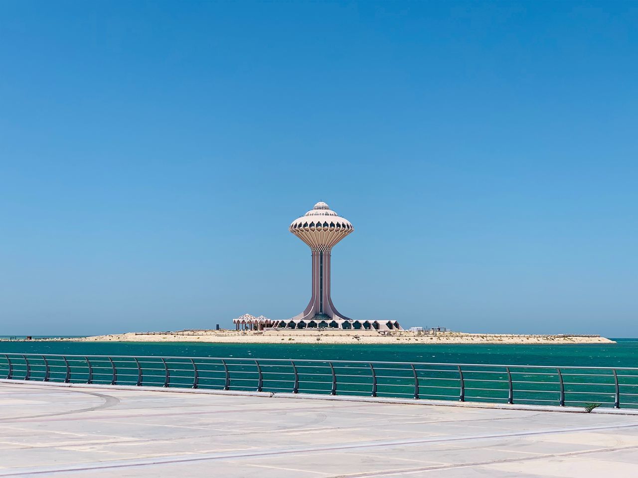 sky, blue, architecture, built structure, sea, water, clear sky, copy space, nature, no people, railing, building exterior, day, tourism, tower, travel, security, travel destinations, beach, outdoors, swimming pool