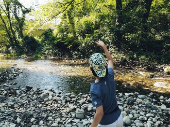 Rear view of person on rock at park