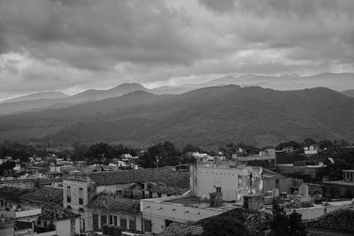 High angle view of houses in town against sky