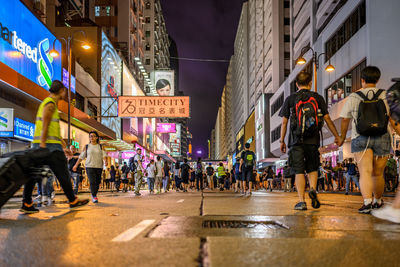 People walking on street in city at night