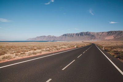 Highway on landscape against sky