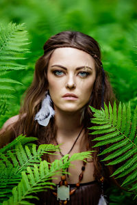 Portrait of beautiful woman in fern