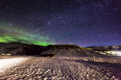 Scenic view of landscape against sky at night