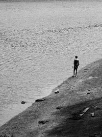 Rear view of man standing on beach