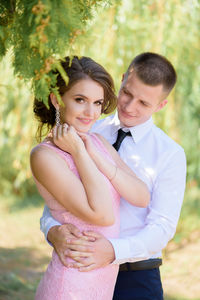 Happy friends standing against blurred background