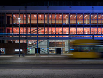 Train on illuminated building at night