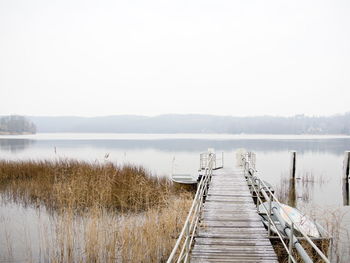 Pier over lake against sky