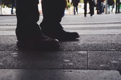 Low section of person walking on road