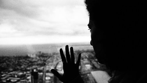 Portrait of silhouette woman in a skyscraper building against sky