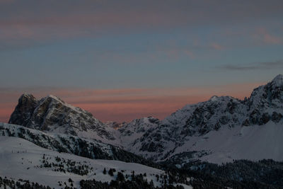 Scenic view of snowcapped mountains against sky during sunset