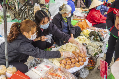 High angle view of people for sale at market stall