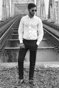 Full length of man standing at railroad station