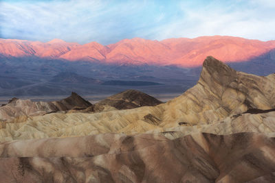 Scenic view of desert against sky during sunset