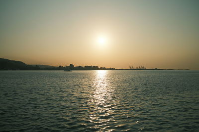 Scenic view of sea against clear sky during sunset