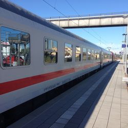 Train at railroad station platform against sky