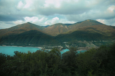 Scenic view of lake and mountains against sky