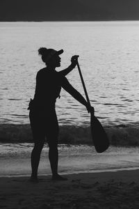 Rear view of silhouette woman walking on beach
