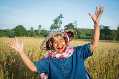 Senior farmer standing on field