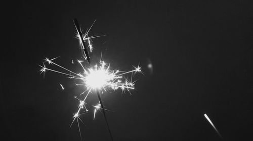 Low angle view of illuminated lights at night