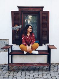 Woman looking away while sitting on seat