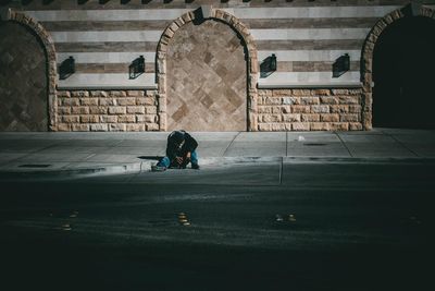 Man sitting on road