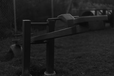 Close-up of metal fence on field