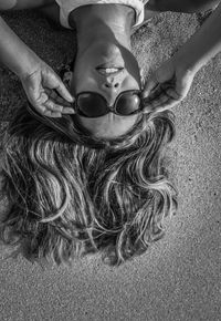 High angle view of woman lying on beach