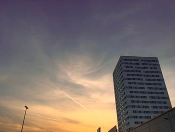 Low angle view of buildings against sky at sunset