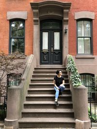 Full length of woman on staircase of building