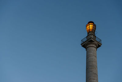 Low angle view of column against clear blue sky