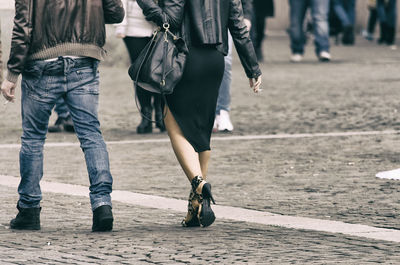 Rear view of people walking on street
